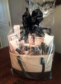 a large gift bag filled with lots of items sitting on top of a wooden table