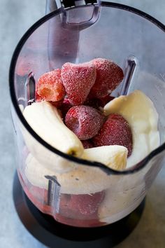 strawberries and bananas are mixed in a blender