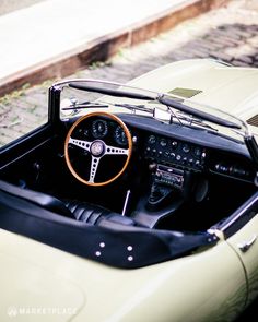 the interior of an old sports car is clean and ready to be used for driving