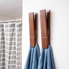 two blue towels are hanging on the wall