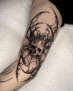 a person with a black and white tattoo on their leg