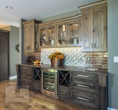 a kitchen with wooden cabinets and a wine rack on the counter in front of it