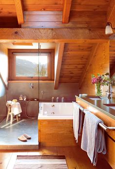 a bathroom with a tub, sink and window