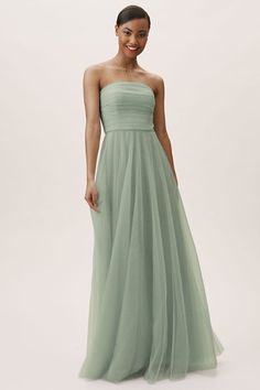 a woman in a strapless green dress