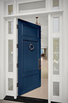 a blue door is open to the living room