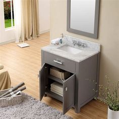 a bathroom vanity with two drawers and a mirror on the wall next to a window