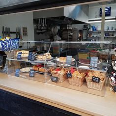 a display case in a bakery filled with lots of food