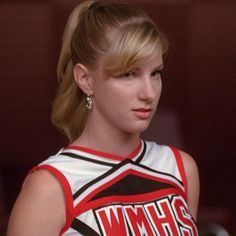 a woman with blonde hair wearing a cheer uniform