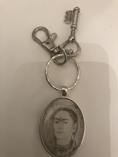 a keychain with an image of a woman on it's front and back sides