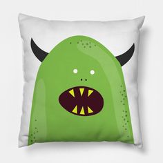 a green monster pillow with horns on it