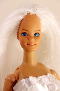 a doll with white hair and blue eyes is wearing a wedding dress in front of a white background