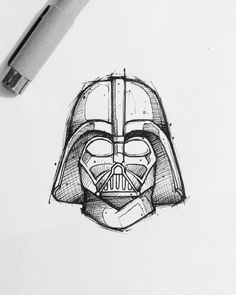 a pencil drawing of a darth vader helmet on top of a piece of paper