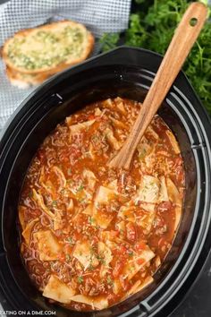 a crock pot filled with pasta and meat