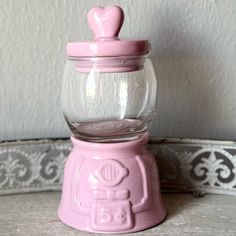 a pink candy dispenser sitting on top of a table