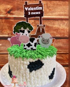 a cake decorated with farm animals on top of it