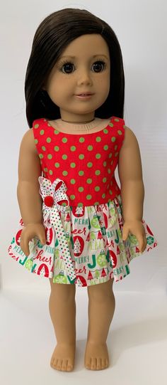 an american girl doll wearing a red and green christmas dress with polka dots on it