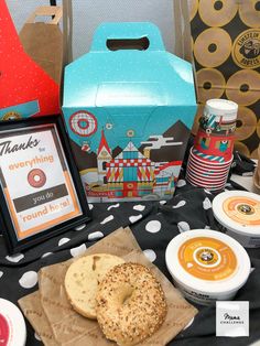 a table topped with donuts and drinks on top of a polka dot table cloth