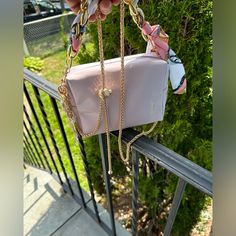 Bag Details: - Metallic Pink Colored Exterior - Gold Colored "Ysl Beaute" Embossed Into Front Exterior Corner - Gold Colored Zipper/Zipper-Pull - "Ysl Beaute" Engraved Into Zipper-Pull - Black Colored Interior With Satin-Lined Texture Bag Measurements: (Approximate) - Length: 7.5" - Width: 2.25" - Height: 5" Designer Pink Square Box Bag, Pink Evening Box Bag With Detachable Handle, Designer Pink Crossbody Box Bag, Pink Box Bag For Evening, Luxury Pink Box Bag For Gift, Luxury Pink Pouch Box Bag, Designer Pink Box Bag For Evening, Designer Pink Evening Box Bag, Chic Pink Box Bag For Gift