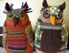 two stuffed owls sitting next to each other