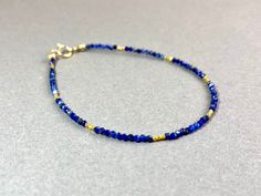 LAPIS LAZULI BRACELET IN GOLD FILLED AND VERMEIL This pretty bracelet, made from dark blue Lapis Lazuli beads has a length of 17.5cm.  If you like another length, please specify when ordering. I send all my jewelry packaged in a small jewelry pouch. MATERIAL Lapis Lazuli beads 1,7 mm 14K Gold filled Clasp Vermeil beads (silver goldplated) 1,5mm Adjustable Lapis Lazuli Jewelry With Faceted Beads, Adjustable Sapphire Bracelets With Gemstone Beads, Adjustable Sapphire Bracelet With Gemstone Beads, Hand-strung Adjustable Sapphire Jewelry, Adjustable Hand-strung Sapphire Jewelry, Adjustable Lapis Lazuli Beaded Bracelet With Faceted Beads, Hand-strung Gold Lapis Lazuli Bracelets, Dainty Blue Bracelets With Faceted Beads, Adjustable Beaded Sapphire Bracelets