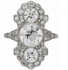 an antique diamond ring with three oval cut diamonds in the center and two smaller round stones on