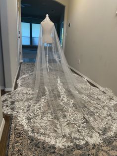 a wedding dress is on display in the hallway