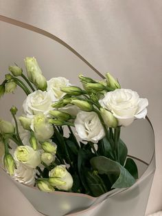 a bouquet of white flowers in a glass vase