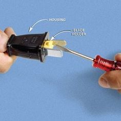 a hand holding a red and black object with instructions on how to wire it up