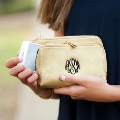 "Must have holiday accessory, perfect for gift giving! The Sloane wristlet is the perfect size to carry credit cards, money and compact makeup. Run around in style with this versatile wristlet. Coordinates perfectly with the Kendall purse and Cambridge Travel bag. Available in gold, blush, camel and black. *6.5\" L x 1.25\" W x 4.5\" H *Vegan Leather *Two Main Pockets with Zipper Closure *Interior Card Pockets *Inside Lining *.375\" X 11.75\" Detachable Wrist Strap *Gold Toned Accents Available Couples Monogram, Vegan Wallet, Gold Clutch, Gold Armband, Wristlet Purse, Gold Monogram, Black Wallet, Monogram Gifts, Wristlet Wallet