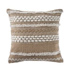 a brown and white pillow with beads on the front, sitting on a white background