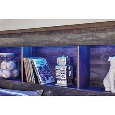 a wooden shelf filled with books and toys