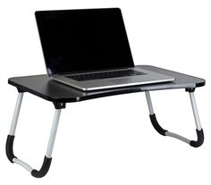 a laptop computer sitting on top of a black desk with a white keyboard and mouse pad