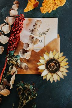 flowers, leaves and an envelope on a table