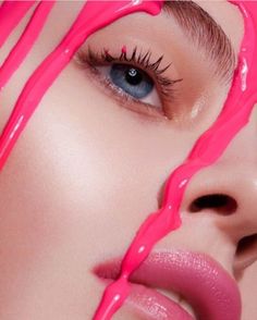 a woman's face is covered in pink liquid