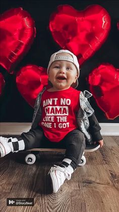 a baby sitting on top of a wooden floor