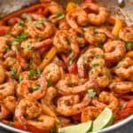 a pan filled with shrimp and vegetables on top of a table