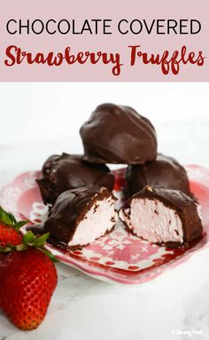 chocolate covered strawberry truffles on a pink plate with strawberries in the background