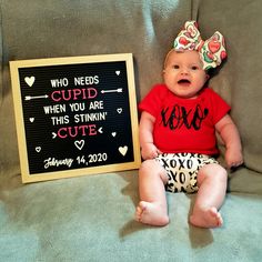 a baby sitting next to a sign that says who needs cupid when you are this stinkin'cute