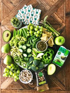 an assortment of fruits and vegetables are arranged on a platter, including broccoli