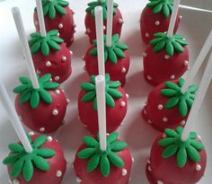 strawberry cake pops with green and white decorations