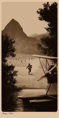 an old photo of people in the water with a plane and mountains in the background