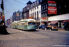 an old bus is driving down the street