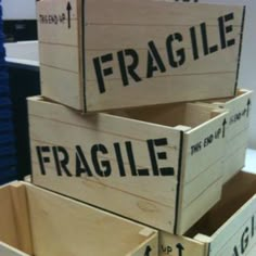 three wooden crates stacked on top of each other with the words fragile written on them