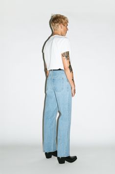 A classic pair of straight-leg jeans inspired by the off-duty uniform of 90's runway models. Designed to pinch just above the hips, the high-rise and roomy straight-leg elongates the leg for a rugged, boyish cut. Constructed in a rigid, non-stretch denim, these go-to jeans only gets better with age. Mens High Rise Jeans, Straight Leg Denim Jeans, Desert Aesthetic Fashion Men, Mens Straight Leg Jeans Outfits, Jeans Style Man, Straight Leg Jeans Outfits Men, Mens Fashion Photoshoot, Mens Night Out Fashion, Rockstar Style Men