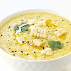 a white bowl filled with soup on top of a table