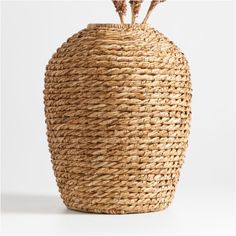 a large woven basket with two flowers in the middle and one flower sticking out of it