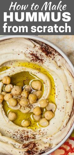 hummus in a white bowl with olives on top