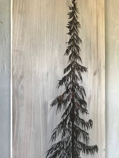 a painting of a pine tree is hanging on the wall