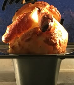 a baked pastry sitting on top of a pan in front of a window sill