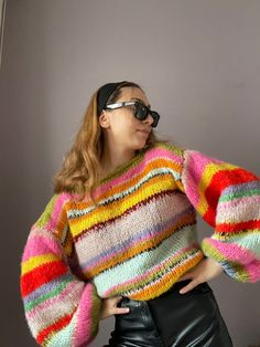 Elevate Your Wardrobe with Our Colorful Striped Sweater Introducing our Colorful Striped Sweater, a true masterpiece of hand-knitted warmth and style. This oversized, unisex sweater is a celebration of color and comfort, making it the perfect addition to your seasonal wardrobe. **Features 🌈 **Vibrant Stripes Our Colorful Striped Sweater boasts a playful and eye-catching design with a blend of striking colors. It's a statement piece that exudes confidence and personality. 🧶 **Hand-Knitted Craftsmanship Each sweater is meticulously hand-knitted with care and precision, ensuring a high level of craftsmanship and quality that's meant to last. 🧥 **Versatile Fashion Whether you're lounging at home, heading out for a chilly adventure, or adding a pop of color to your everyday attire, this swea Trendy Slouchy Knitted Sweater, Oversized Knitted Acrylic Tops, Oversized Knitted Cropped Sweater For Fall, Trendy Hand Knitted Sweater One Size, Trendy Hand Knitted One Size Sweater, Trendy Hand-knitted One-size Sweater, Oversized Hand Knitted Acrylic Knitting Pattern, Trendy Hand Knitted Sweater, Hand Knitted Acrylic Sweater For Spring